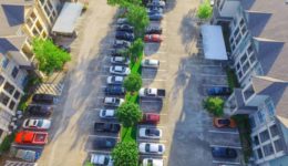 Aerial view of apartment garage with full of covered parking