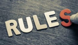 Hand arrange wood letters as Rules word Hand arrange wood letters as Rules word
