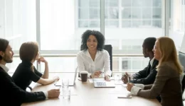 Smiling friendly african female boss leading corporate diverse team