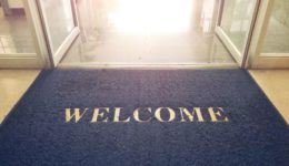 Welcome blue mat in front of door, shop