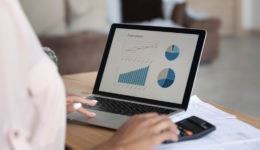 Close up African American woman working financial project with statistics