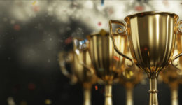 Golden trophy cup on dark background. copy space for text. 3d rendering.