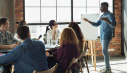 African-american leader lecturing his employees in office