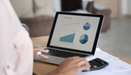 Close up African American woman working financial project with statistics