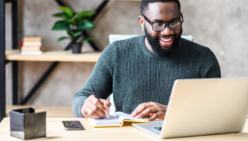 An African-American guy using laptop in the office