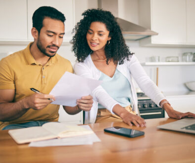 Couple, insurance paperwork and budget planning with laptop, bills and finance with taxes and mortgage. Financial documents, payment and loan with policy, audit and review with asset management