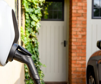 Wall mounted car charging unit to supply power to electric vehicles with copy space on house wall