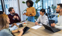 International workers group and team leader having teamwork discussion managing project at work in meeting room.