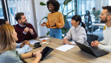 International workers group and team leader having teamwork discussion managing project at work in meeting room.