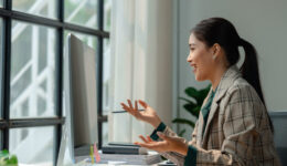 a businesswoman is attending video conference with her team to discussion about marketing strategy, brainstorming for planning to increase more sale, meeting via computer because must to quarantine